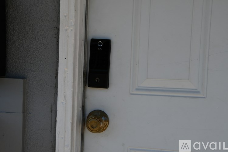 A doorbell is mounted on a white door.