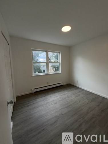 A room with a window and a door.