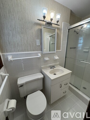 A white toilet sits next to a sink in a bathroom.