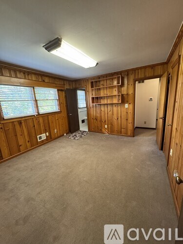 A room with wooden walls and a carpeted floor.