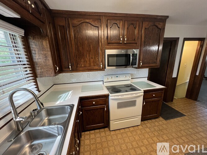 A kitchen with wooden cabinets and white appliances.