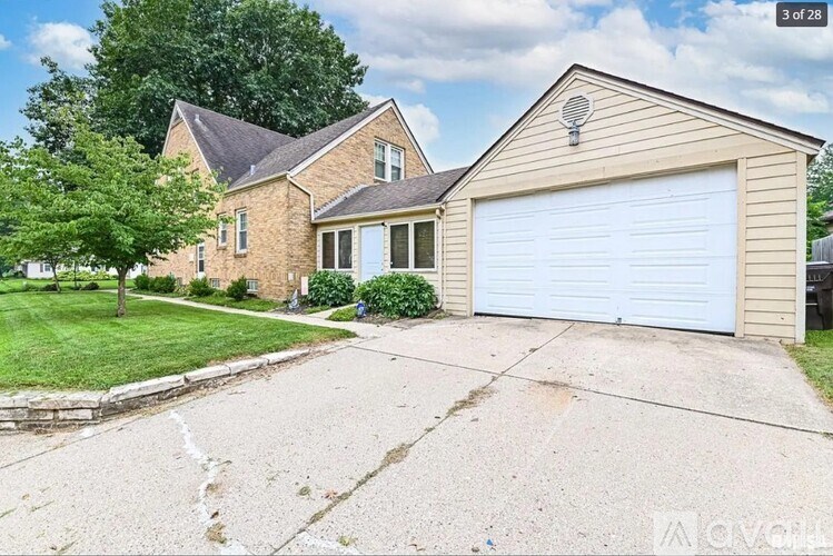 A two-story house with a garage is for sale.
