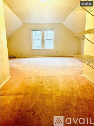 A room with wooden flooring and a window is available for rent.