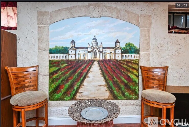 A mural of a church and vineyard is painted on a wall.