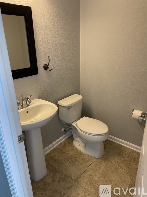 A white toilet sits next to a sink in a bathroom.
