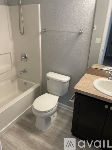 A bathroom with a toilet, sink, and bathtub.