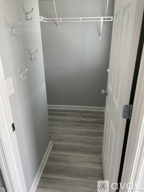 A white door with a black handle is on the right side of the image.