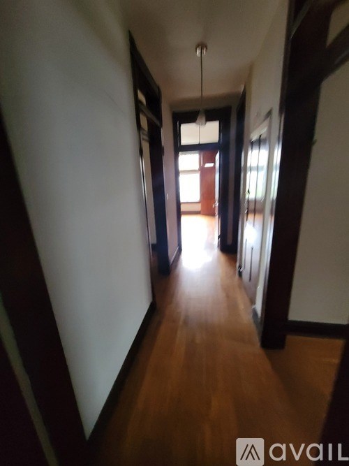 A long hallway with a light at the end.