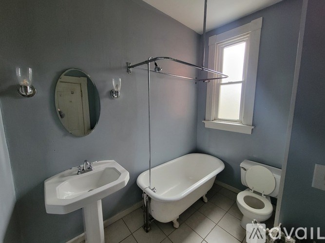 A bathroom with a white sink, toilet, and bathtub.