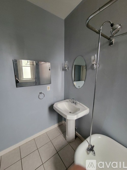 A bathroom with a white sink and a white toilet.