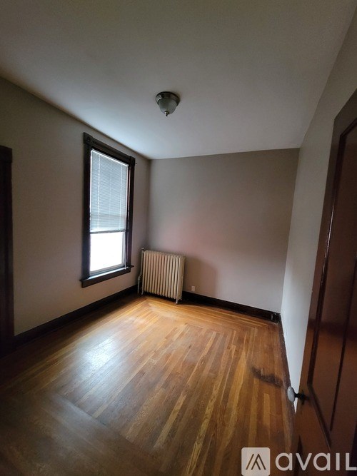A room with wooden floors and a window.