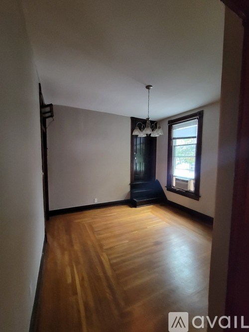 A room with wooden floors and a window.