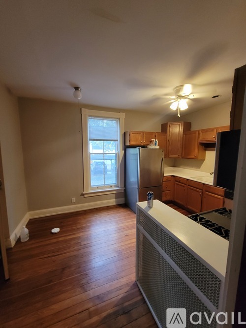 A kitchen with wooden floors and a stove top oven.