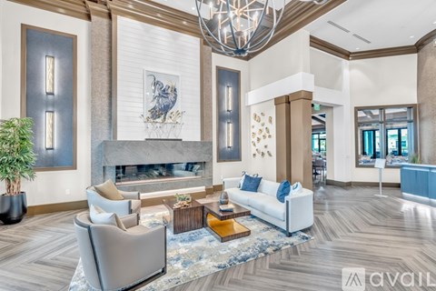 A living room with a fireplace and a large painting above it.