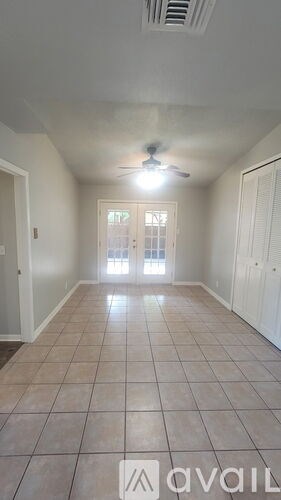 A room with tiled flooring and a ceiling fan.