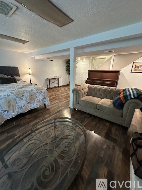 A bedroom with a bed and a couch.