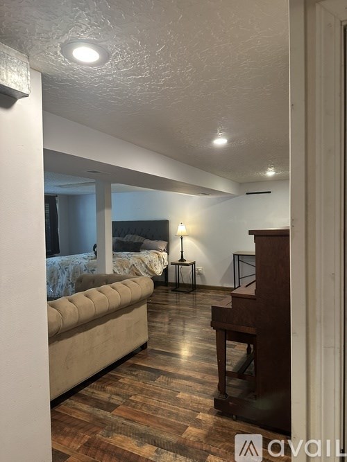 A living room with a piano and a couch.