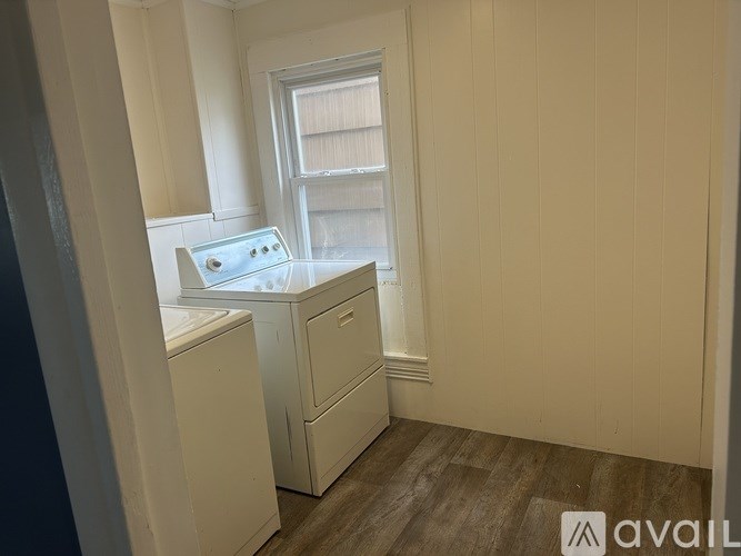A small laundry room with a washer and dryer.