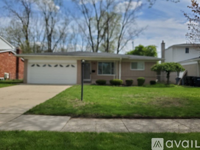 A house with a garage is for sale.