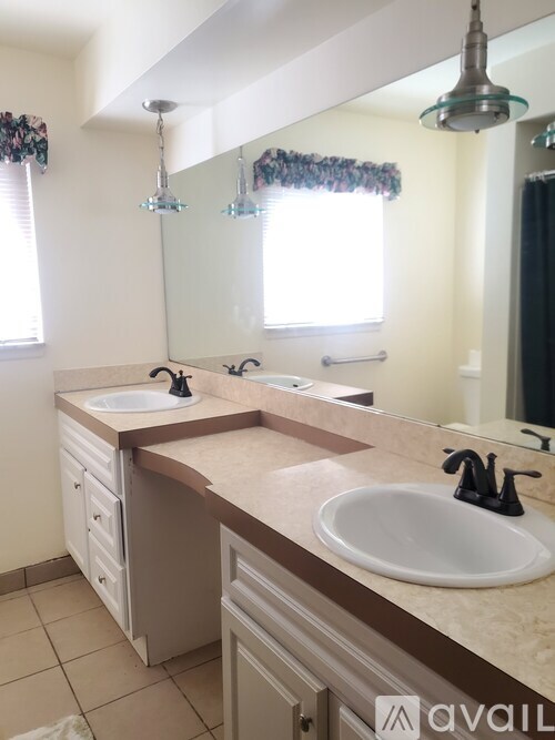 A bathroom with a sink and a mirror.