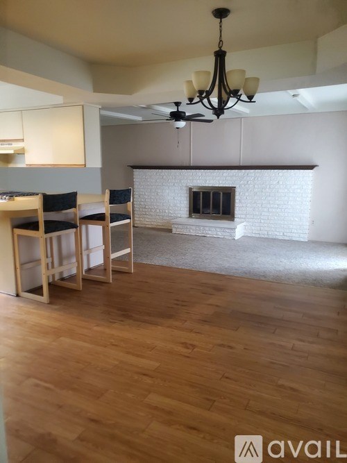 A living room with a fireplace and a dining table.