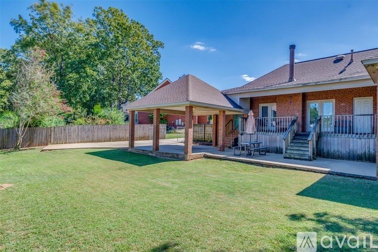 A house with a covered patio and a fence.
