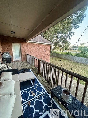 A balcony with a table and a cup of coffee.