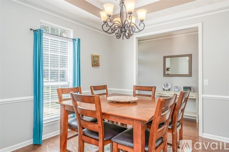 A dining room with a wooden table and chairs.
