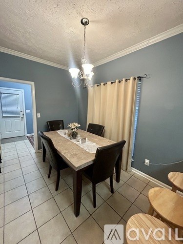 A dining room with a table set for four.
