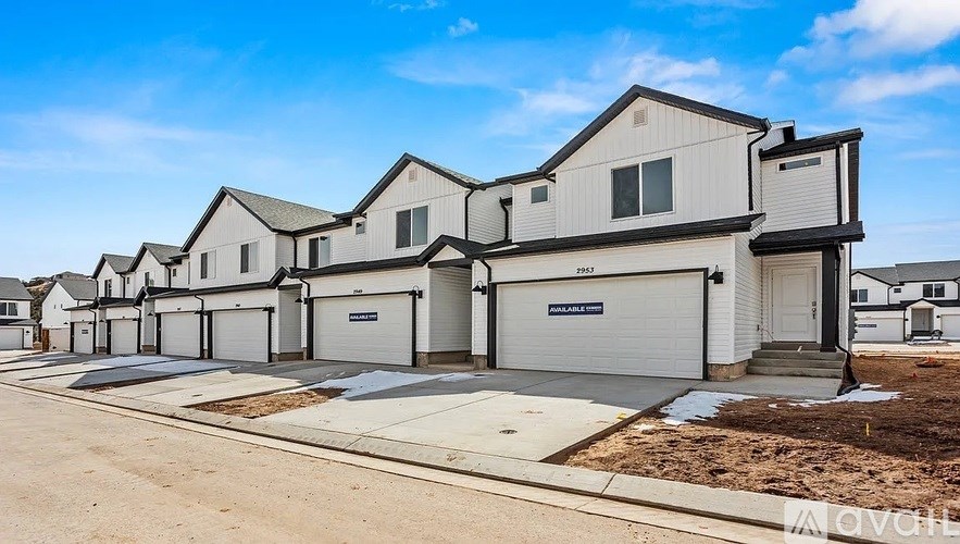 A row of new houses with garages in front.