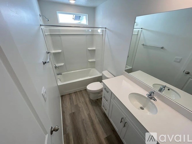 A bathroom with a toilet, sink, and bathtub.
