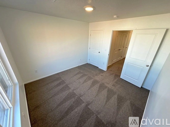 A room with a carpeted floor and white walls.