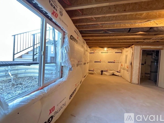 A room under construction with insulation on the walls.
