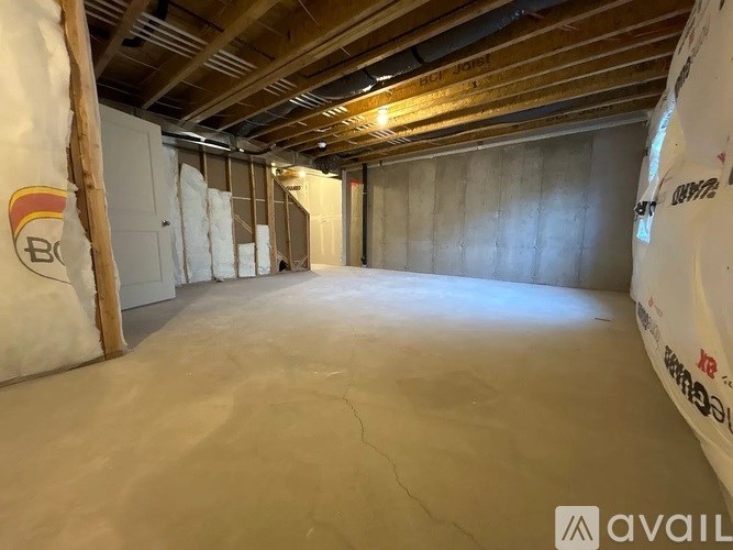 A room under construction with insulation on the walls.