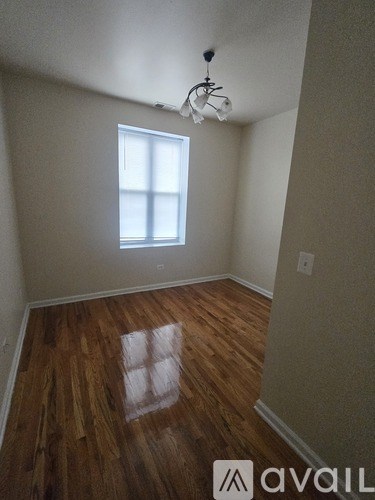 A room with wooden floors and a window.