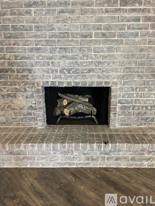 A fireplace with a fire burning inside.