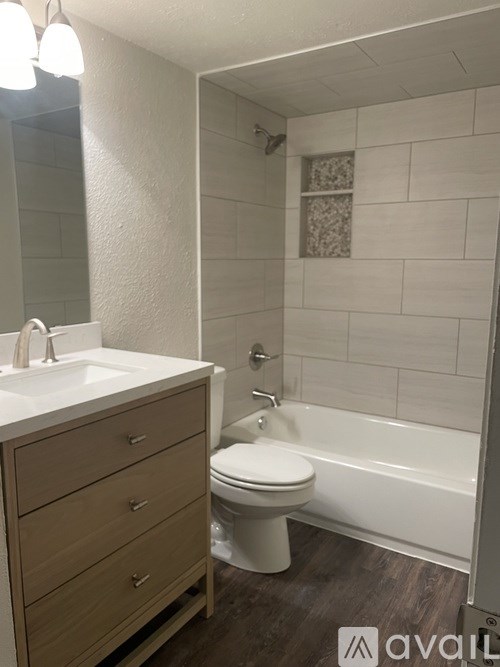 A bathroom with a toilet, sink, and bathtub.