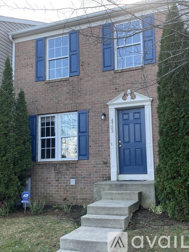 A house with a blue door and steps leading up to it.