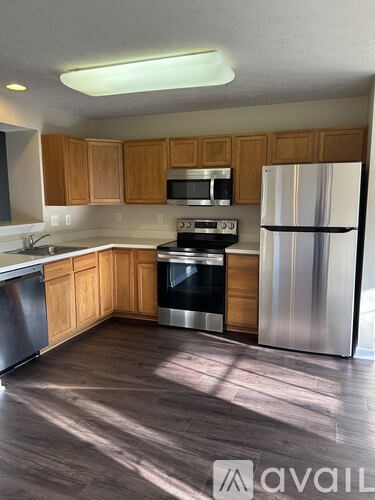 A kitchen with wooden cabinets and stainless steel appliances.