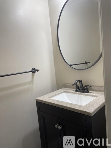 A bathroom with a sink and a mirror.