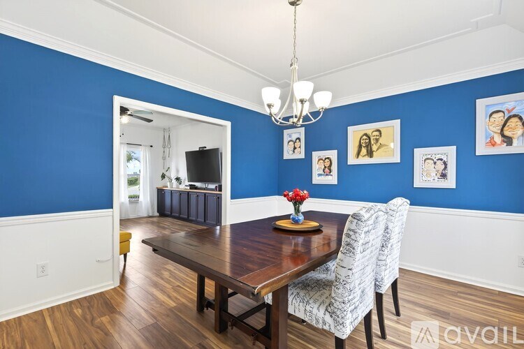 A dining room with a wooden table and chairs.