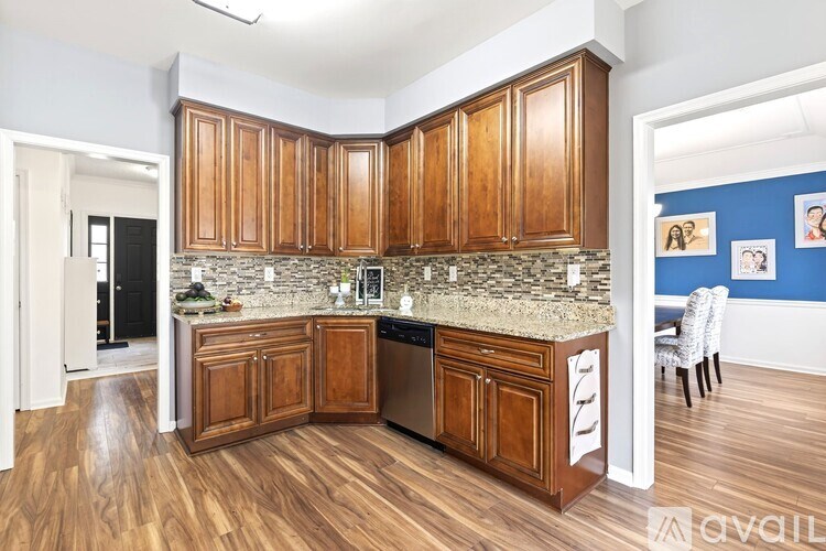 A kitchen with wooden cabinets and a stone countertop.