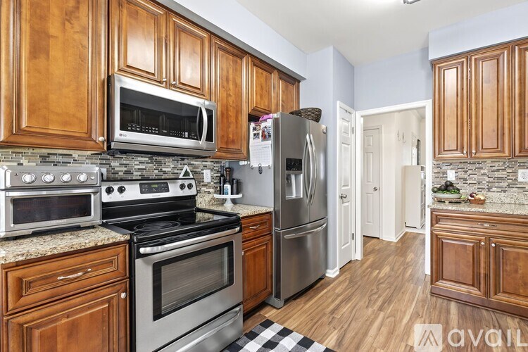 A kitchen with wooden cabinets and stainless steel appliances.
