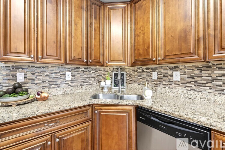 A kitchen with wooden cabinets and a granite countertop.