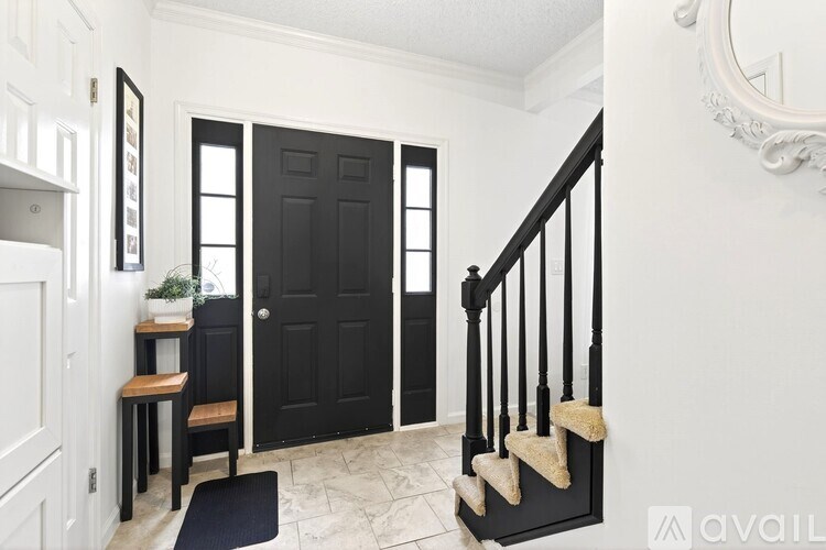 A black door is at the end of a staircase.