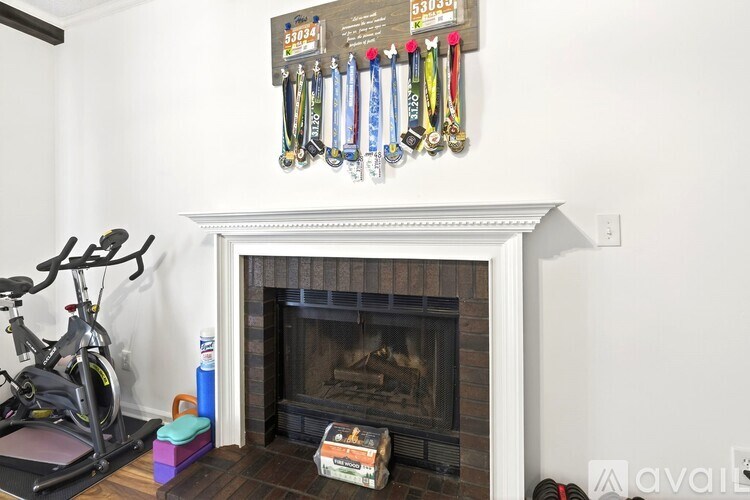 A fireplace with a shelf above it that has a collection of medals hanging on it.