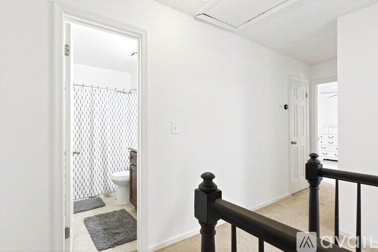 A bathroom with a toilet and a shower with a glass door.