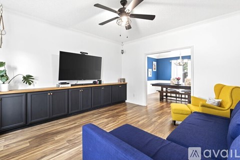 A living room with a blue couch and a television.