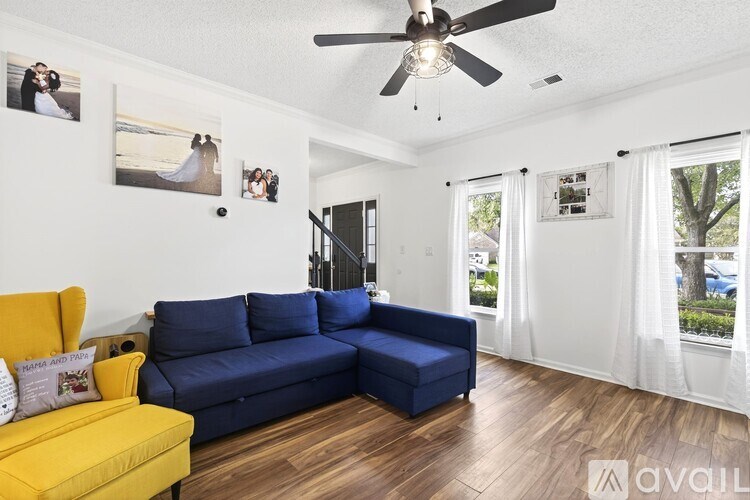 A living room with a yellow sofa and a blue couch.