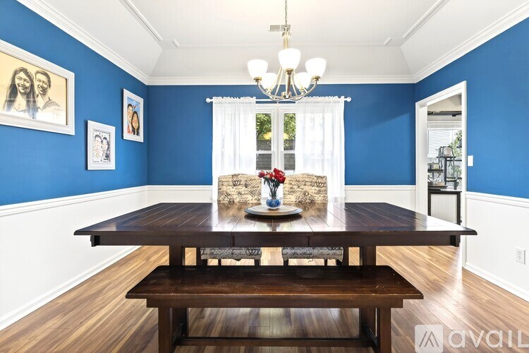 A dining room with a wooden table and chairs.